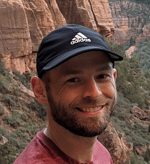 Alek smiling while hiking Mount Zion